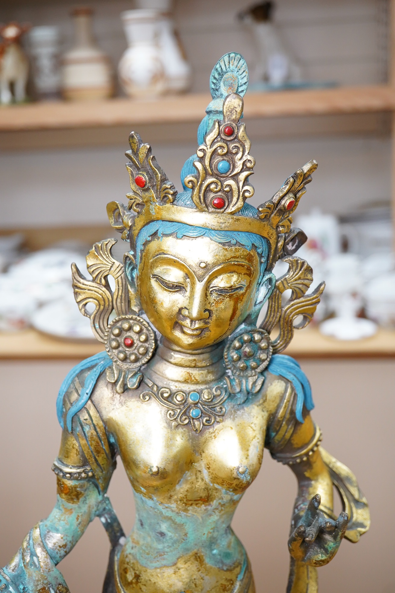 A Tibetan brass model of Goddess Tara, inscription to base reads ‘Ming Dynasty Yongle year’, 53cm. Condition - poor to fair